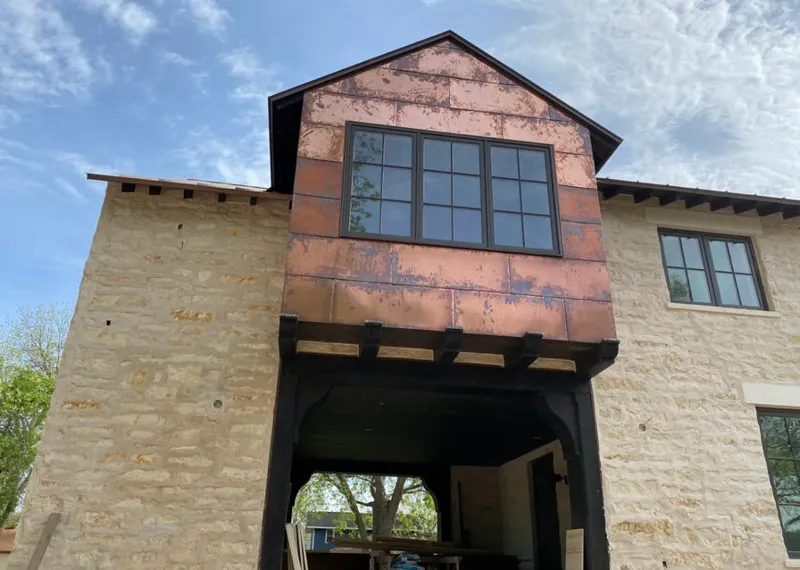 Copper metal panel facade on a stone building for Roof Repair in Roseville