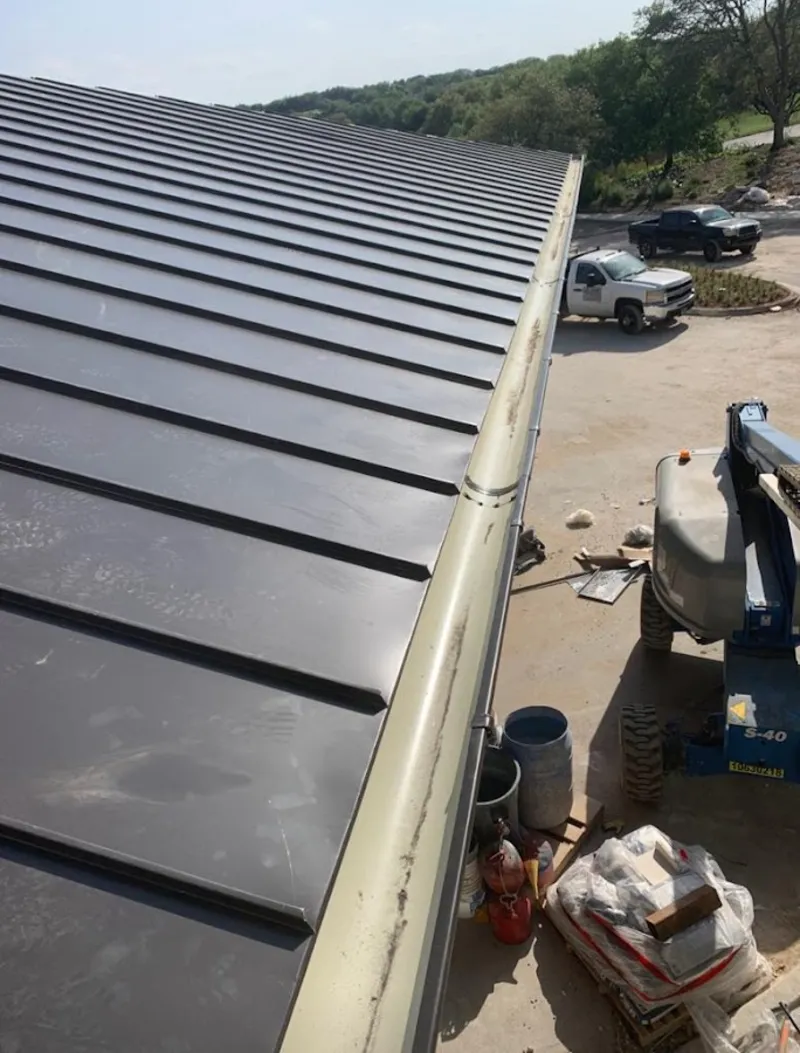 Standing seam panel and gutter detail on a metal roofing jobsite in Roseville